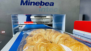 Picture shows packed cookies on a conveyor belt of a Minebea Intec metal detector