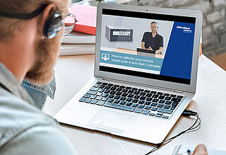 Man sitting in front of a laptop attending a seminar