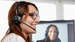 A woman with a headset in profile