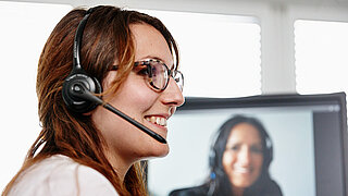 A woman with a headset in profile