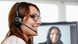 A woman with a headset in profile