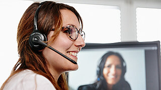 A woman with a headset in profile